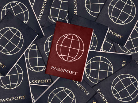 Red passport with blue ones on background. Official documents with globe at cover. Immigration, living in country with different nationality. High quality photoの写真素材