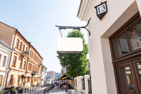 Old city signboard mockup. Classic board of rectangle shape on cafe, hotel, museum, bookstore wall with place for text. High quality photoの写真素材