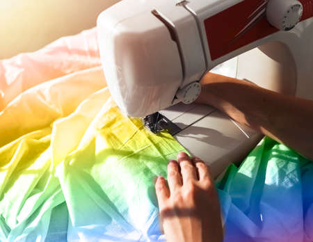 Sewing LGBT, LGBTQ plus fabric flag for pride month. High quality photo