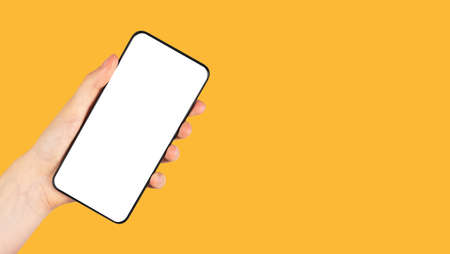 Banner with hand holding phone mockup in rotated position on orange background. Telephone template...