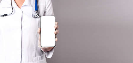 Doctor holding smartphone app for health care, mockup.の写真素材