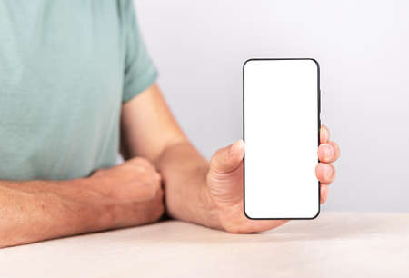 Man holding phone mockup in vertical position. Android with empty screen for advertising. Male...