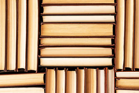 Hardback books heap in library, bookstore. Reading education concept. literature background. high quality photoの写真素材