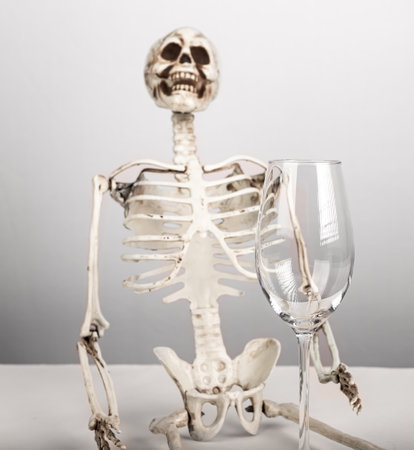 Alcohol addiction. Skeleton holding empty glass. Alcoholism, mental and physical health problems...