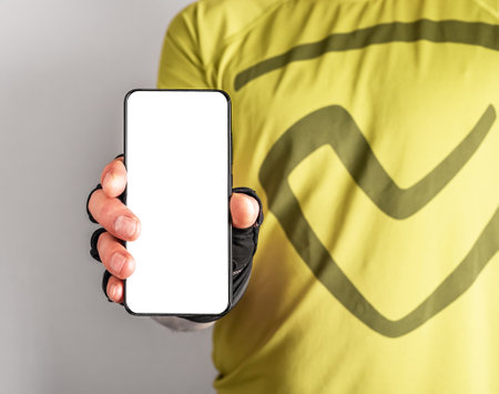 Sport application mockup, blank white mobile phone screen in athlete hand. high quality photoの写真素材