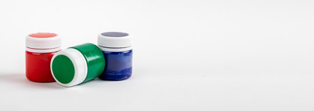 Gouache jars of basic RGB colors. Red, green, blue paints in bottles. AD banner with copy space for text.の写真素材
