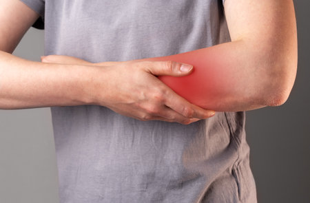 Hand pain closeup. Contusion, trauma of arm, massaging it closeup. High quality photoの写真素材