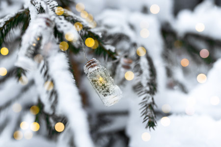 Garland lights on fir tree branches covered with snow. Forest in frost, snowy season, weather. high quality photoの写真素材