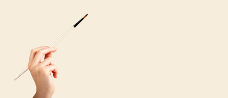 Hand with paintbrush, paintbrush painitng, making brushstroke. Ad banner, background. high quality photoの写真素材