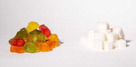 Gummy jelly bears, chewing fruit candies and refined sweet sugar piles. Consumprion and addiction. High quality photoの写真素材