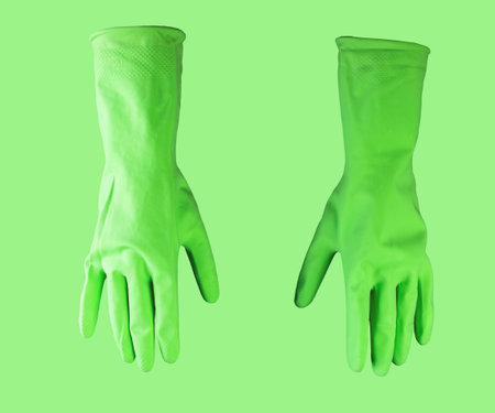 Cleaners green rubber gloves for cleaning service, housework.の写真素材