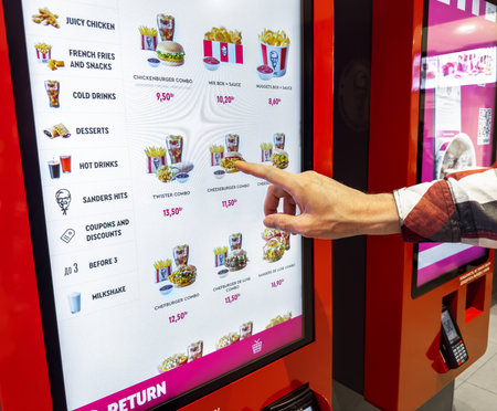 Minsk Belarus May 14 2023 Hand choosing fast food at self ordering vending machine, clicking on...