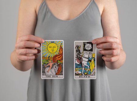 Berlin Germany May 16 2023 Sun and Death tarot cards in ahnds of fortune teller.のeditorial素材