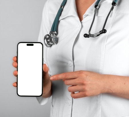 Lodz, Poland June 19 2023 Doctor hands showing smth on mobile phone screen mockup.のeditorial素材