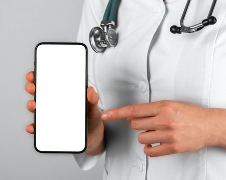 Mobile phone mockup in doctor hands closeup.の写真素材