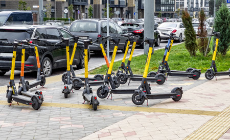 Many e-transport, electric rental kick scooters on city streetのeditorial素材