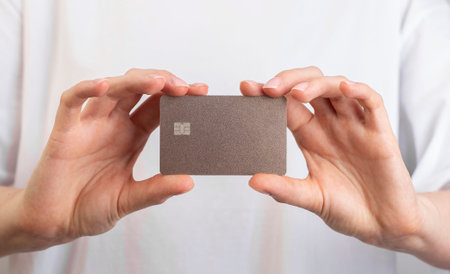 Plastic bank card mockup in hands. Holding bankcard mock upの写真素材