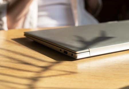 Closed laptop on wooden desk. Finished end done workの写真素材