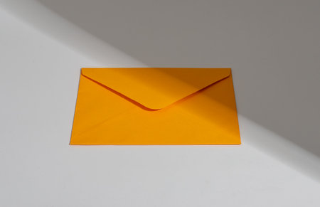 Orange paper envelope. Letter, mail, post, correspondence concept, sunlight.の写真素材