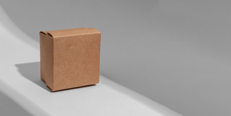 Kraft carton box cover of square shape, cardboard package. Banner background.