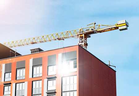 Construction cranes and new condo developments in urban settings. Showcasing the engineering and industrial equipment behind modern architecture. Perfect for real estateの写真素材