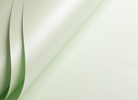 Paper with a rich texture and glowing gradient in pale green and frosted mint tones. The minimalist, monochrome surface features delicate folds and layered lines, creating a subtleの写真素材