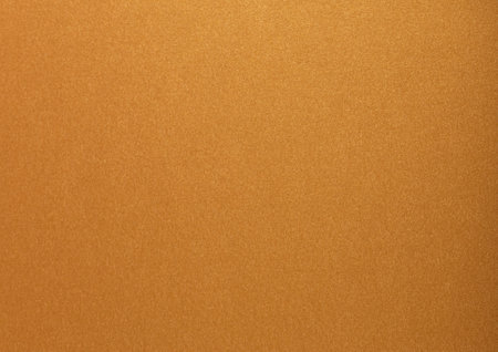 Gold paper with a glossy, metallic texture featuring soft, smooth surfaces in brass and bronze tones. The elegant and stylish design sparkles with a bright, shiny finish, perfectの写真素材