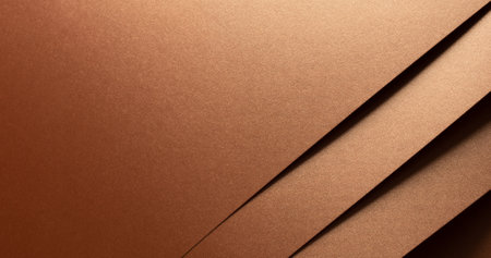 Copper metallic texture with layered folds and a reflective surface. Diagonal geometric lines create...