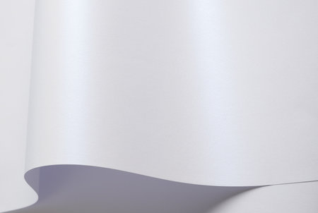 Pearle glossy paper background with a glowing iridescent texture. Pastel shine and smooth surface ideal for gift wrapping, Christmas cards, or premium labels. Elegant and modernの写真素材