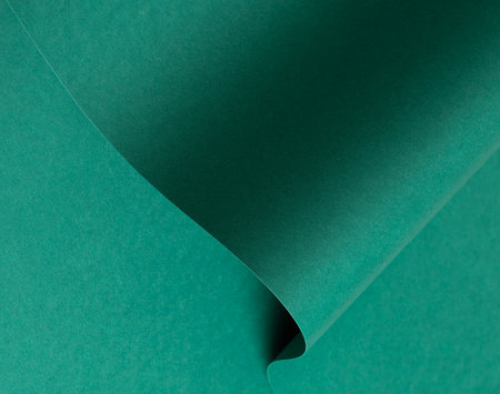 Emerald green paper background with a matte finish and subtle wavy texture. Deep green tones create a bold and luxurious design, perfect for premium stationery, decorative wrappingの写真素材