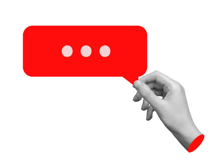 Hand holding a red speech bubble, feedback, review, or online comment. Concept of communication, gossip, or comments. Isolated on white background.の写真素材