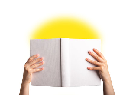 Hands holding open spread book mock up, blank empty hard cover, hardback mockup isolated on white background.の写真素材