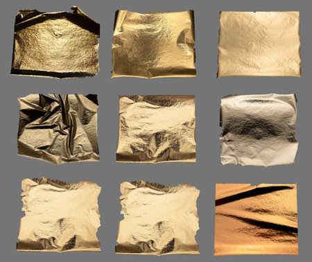 Gold foil with crumpled, shiny metallic texture creates a reflective, luxurious surface. Torn and folded edges add abstract design, perfect for premium packaging, decorative art, and fashion elementsの写真素材