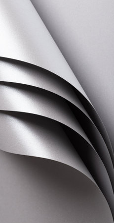 Silver and gray paper texture with metallic shine and pearlescent finish, folded and rolled design with smooth, clean surface, modern minimalistic abstract composition, creating an elegant, luxuriousの写真素材