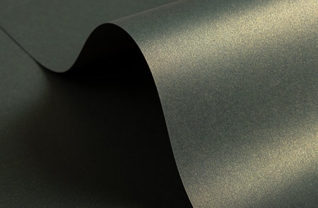 Paper texture with wavy folded surface, glossy finish and glistering shimmer, warm yellowish and...