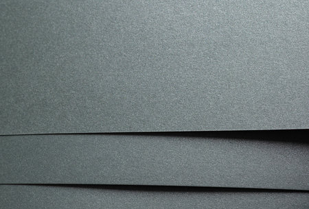 Paper texture with sage green tone, glossy shimmering surface and glitter overlay, elegant layered designer paper with forest green and dark green accents, smooth minimalistic composition.の写真素材