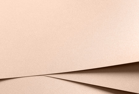 Paper texture with soft beige and pink tones, clean layered surface with metallic shimmer and geometric lines, luxurious designer paper with glistering contrast, elegant modern composition and smoothの写真素材