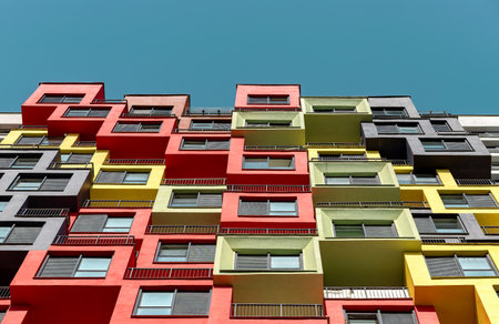 Modern building with large glass windows, showcasing high-rise residential apartments and condos. Sleek facade and balcony design for urban living, investment, and real estate. Multistory structureの写真素材