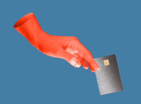 Hand holding a credit card with a chip, symbolizing security and alertness against fraud and phishing. Red and dark background emphasizing the danger of digital scams, hacking, and online theft.の写真素材