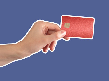Hand holding a red bank card with chip, symbolizing secure financial transactions and luxury purchases. Elegant design for debit, cashback, and online shopping. Isolated on white background.の写真素材