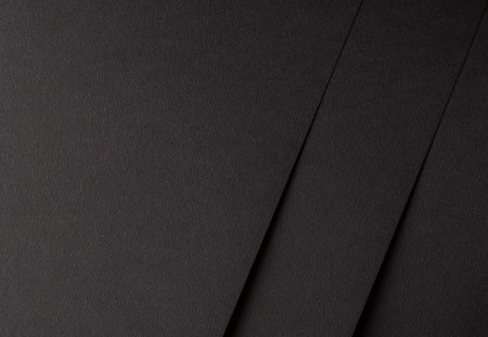 Black matte paper texture with a rich, geometric design, featuring simple, abstract lines and patterns. Elegant, modern finish perfect for trendy, stylish decor and high-end fashion concepts.の写真素材