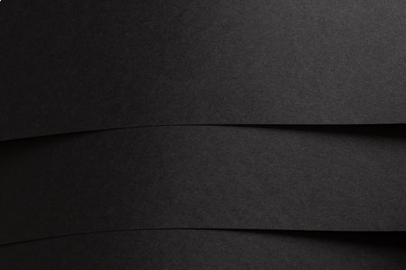 Black matte paper texture with a premium, sleek finish, featuring a minimalistic design. Elegant, modern backdrop perfect for trendy fashion and stylish decor.の写真素材