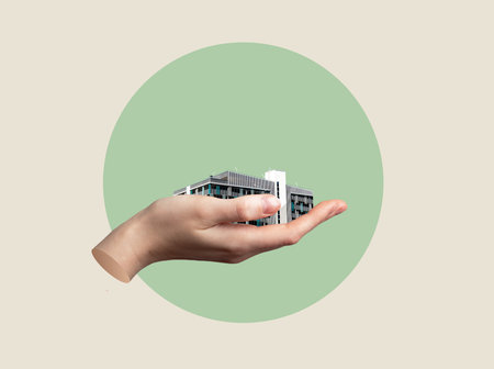 Hand holding building with parking lot as smart urban infrastructure concept. Modern city planning symbol with transport facility, ownership, convenience and development solution.の写真素材