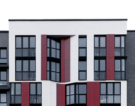 Apartment building with modern geometric facade featuring wooden, red, and black panels. Sharp contrast design with glass balconies and vertical structure in urban housing. Isolated on whiteの写真素材