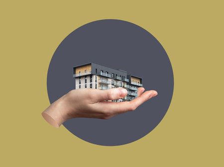 Hand holding modern condo building in symbolic collage. Creative real estate concept representing ownership, mortgage, investment, shelter, and urban property offer. Isolated on white background.の写真素材