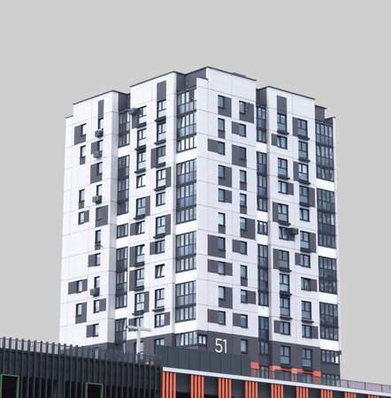 Highrise apartment building with geometric facade and tall elevation. Modern urban tower representing contemporary housing, real estate investment and metropolitan development. Isolated on whiteの写真素材
