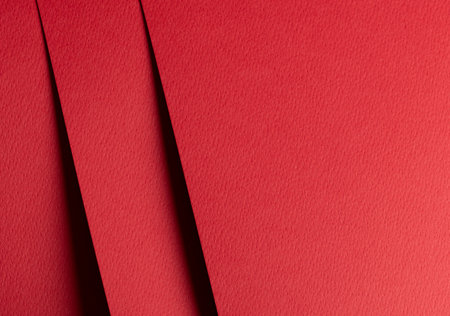 Premium red designer paper sheet with smooth matte texture. Bright, festive background with minimalistic design and sassy, happy color. Clean edges and overlay, perfect for cheerful, elegant projects.の写真素材