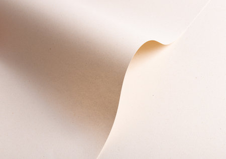 Elegant designer paper in creamy beige tones with folded and wavy shape. Natural recycled material...