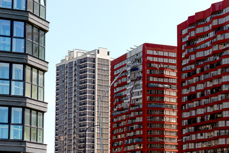 Construction of modern residential building in developing district. High rise apartment complex with...