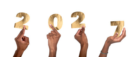 African hands holding golden metallic 2027 number in festive New Year celebration. isolated on white...